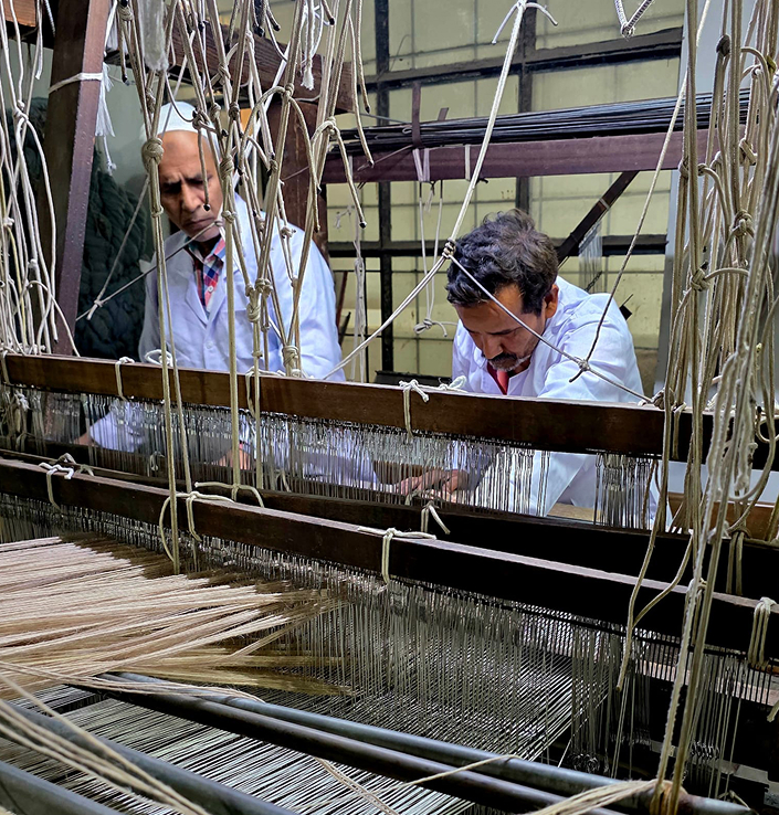 Skilled artisans weaving Elements Collection luxury carpet on loom – Habit Collection